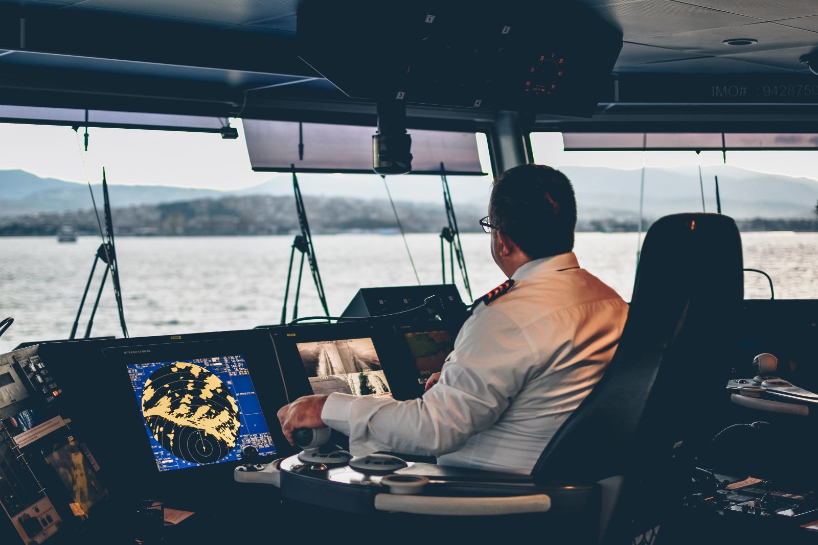 Officer at the bridge controls of a vessel