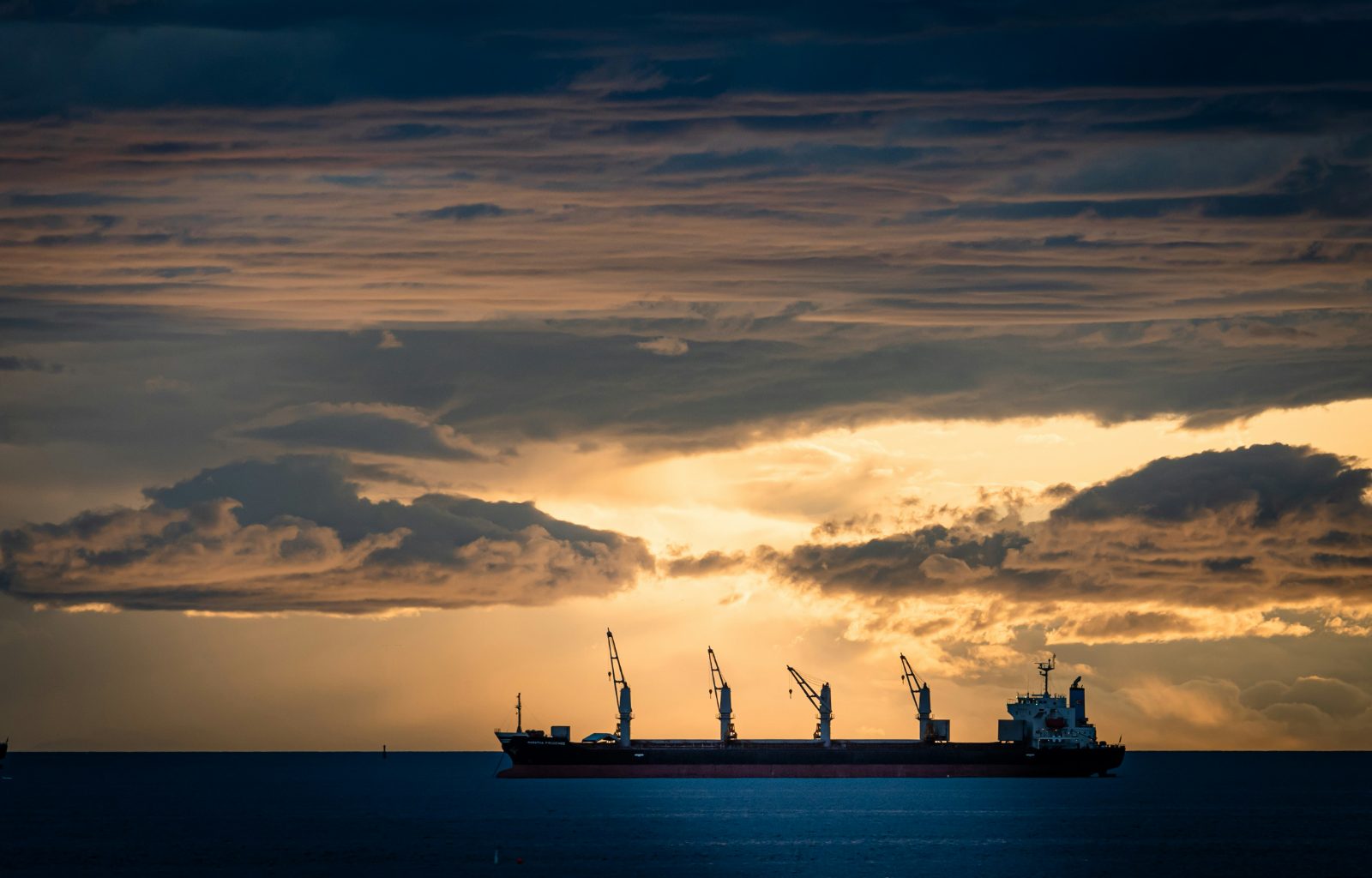 Bulk carrier at anchor at dusk